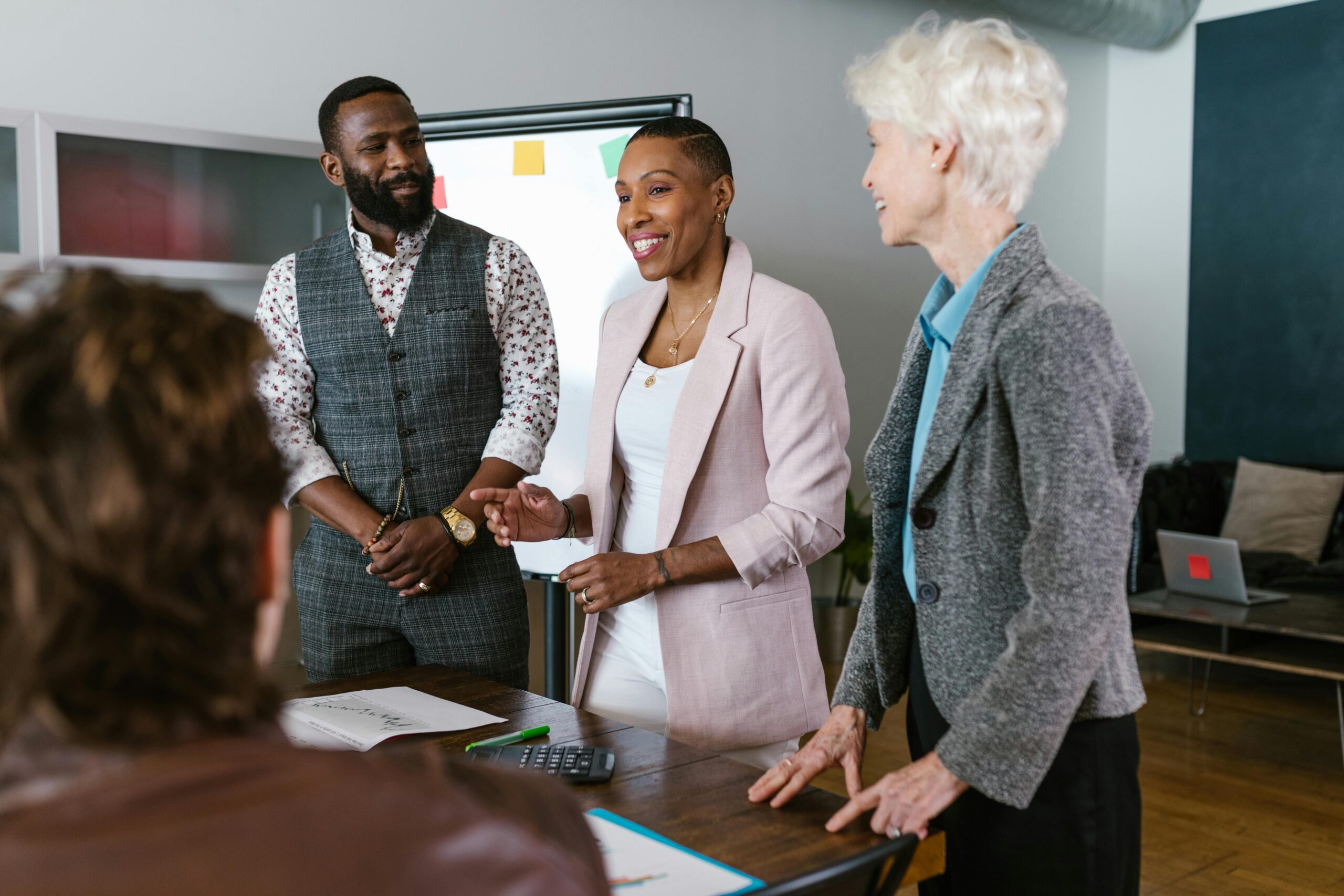 Business professionals discussing fundraising strategy during a team meeting in a modern office.